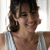 The Minimalist Scandinavian Ray necklace by MeganCollinsJewellery with the delicate circle and bar, are an abstract representation of the sun. Wear it as a reminder to shine your inner light.