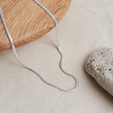 Designed by Megan Collins, the "Flow Necklace" is a classic must-have in every minimalists’ wardrobe. Created to represent the perfect equilibrium between stability and change.