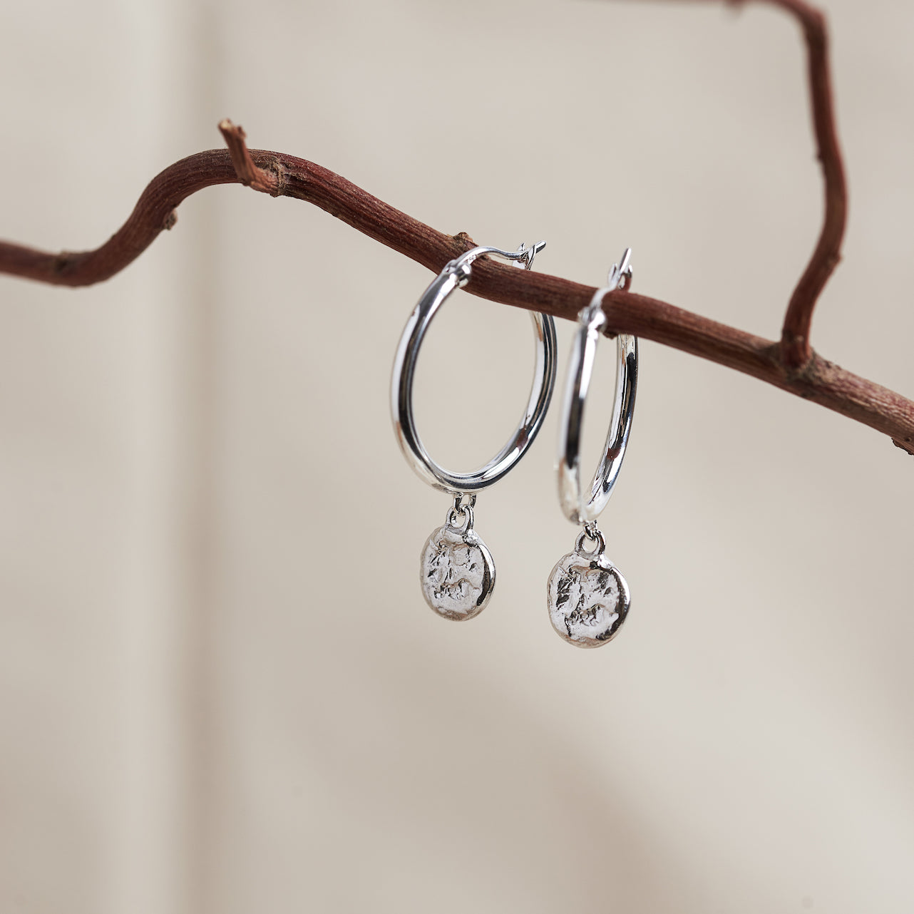 Designed by Megan Collins, the "Balance Hoops" are made to be worn as a reminder that life's beauty lies in the balance between hard work and play.