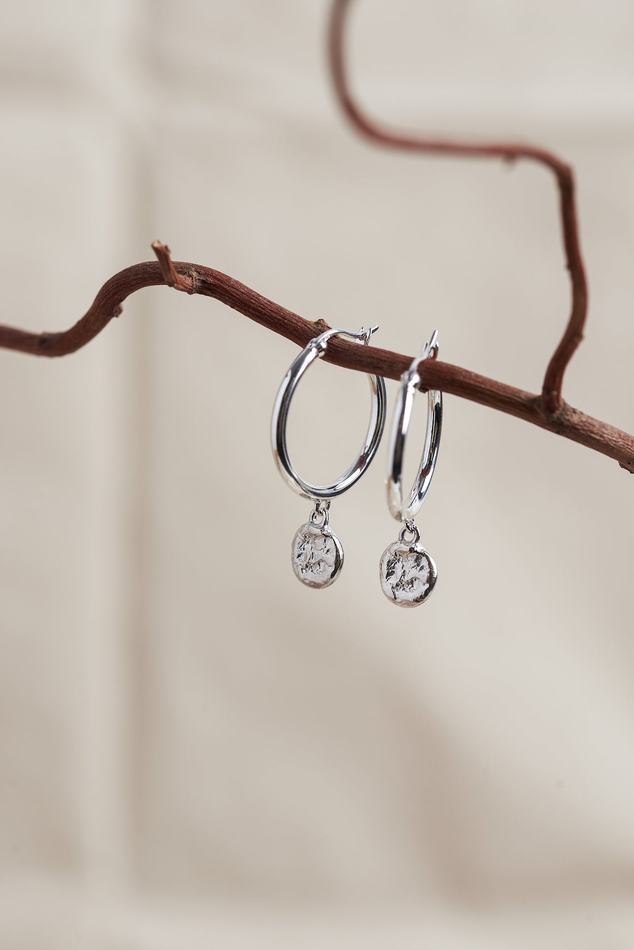 Designed by Megan Collins, the "Balance Hoops" are made to be worn as a reminder that life's beauty lies in the balance between hard work and play.