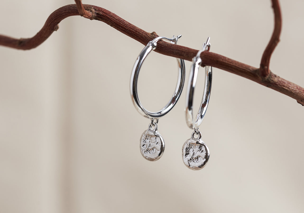 Designed by Megan Collins, the "Balance Hoops" are made to be worn as a reminder that life's beauty lies in the balance between hard work and play.