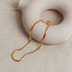 Designed by Megan Collins, a Classic minimalist piece, the "Flow Anklet," represents the dance between both stability and change.