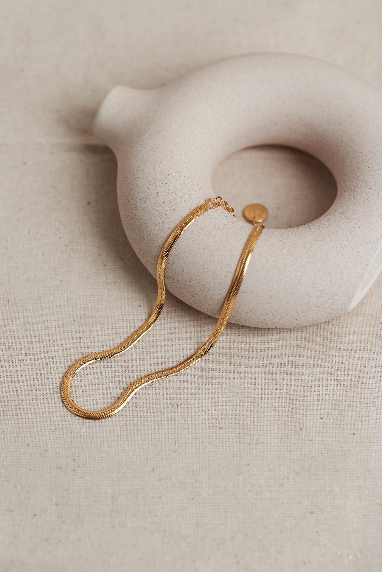 Designed by Megan Collins, a Classic minimalist piece, the "Flow Anklet," represents the dance between both stability and change.