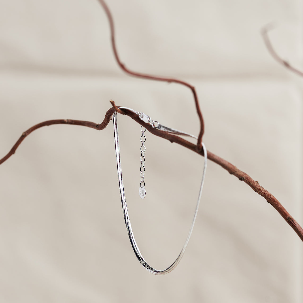 Designed by Megan Collins, a Classic minimalist piece, the "Flow Anklet," represents the dance between both stability and change. 