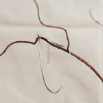 Designed by Megan Collins, a Classic minimalist piece, the "Flow Anklet," represents the dance between both stability and change.