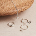 Designed by Megan Collins, the "Balance Hoops" are made to be worn as a reminder that life's beauty lies in the balance between hard work and play.