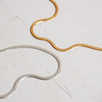 Designed by Megan Collins, a Classic minimalist piece, the "Flow Anklet," represents the dance between both stability and change.