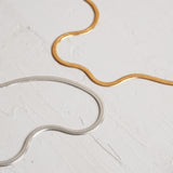 Designed by Megan Collins, a Classic minimalist piece, the "Flow Anklet," represents the dance between both stability and change. 