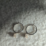 Designed by Megan Collins, the "Balance Hoops" are made to be worn as a reminder that life's beauty lies in the balance between hard work and play.